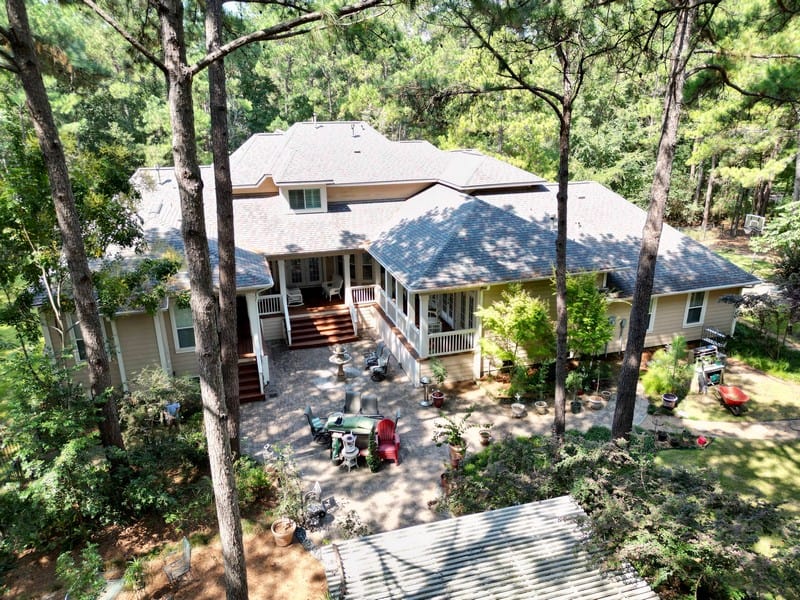 Spacious Texas home surrounded by tall trees and nature.